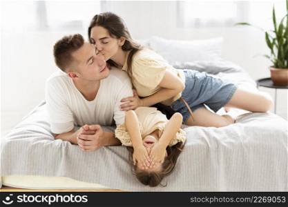 family having cute moment together bedroom