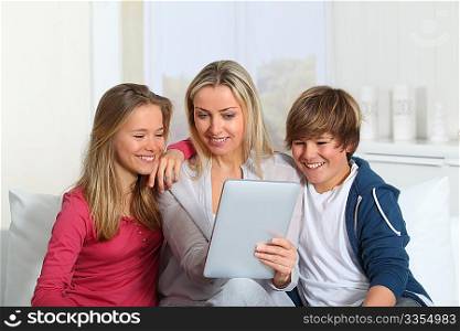 Family having fun at home using electronic tablet