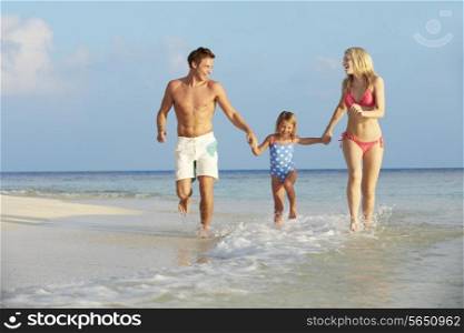 Family Having Fun In Sea On Beach Holiday