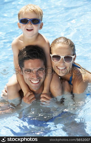 Family Having Fun In Swimming Pool