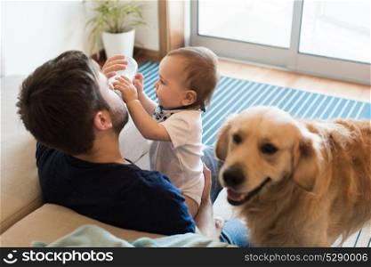 Family having fun with a feeding bottle - Father, baby and dog!