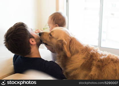 Family having fun with a feeding bottle - Father, baby and dog!