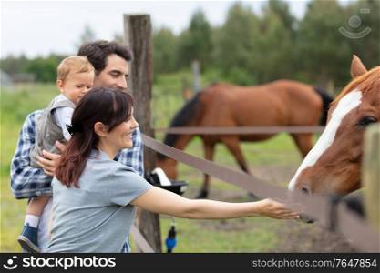 family having holidays in a horse farm