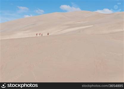 Family hiking the dunes, Great Sand Dune National Park, Sangre de Cristo Mountains near Mosca, Colorado