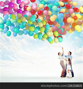 Family holding colorful balloons