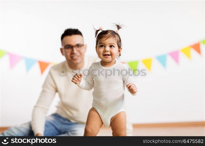 family, holidays and people concept - happy father and little daughter on birthday party. happy father and little daughter at birthday party. happy father and little daughter at birthday party