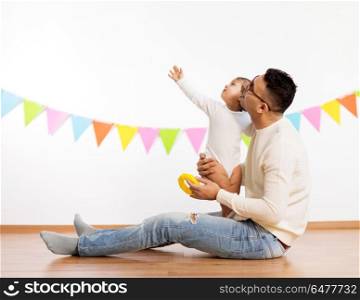 family, holidays and people concept - happy father and little daughter on birthday party. happy father and little daughter at birthday party. happy father and little daughter at birthday party