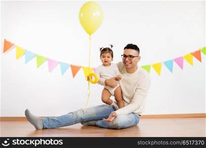 family, holidays and people concept - happy father and little daughter with helium balloon on birthday party. father and daughter with birthday party balloon. father and daughter with birthday party balloon