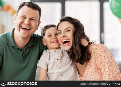family, holidays and people concept - portrait of happy mother, father and little son at home party. happy family with little son at birthday party