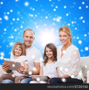 family, holidays, christmas technology and people - smiling mother, father and little girls with tablet pc computers over blue snowy background