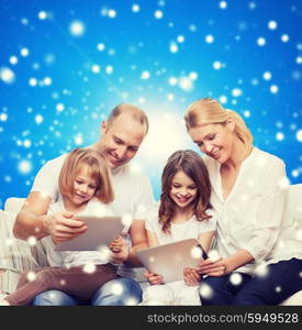 family, holidays, christmas technology and people - smiling mother, father and little girls with tablet pc computers over blue snowy background