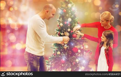 family, holidays, generation and people concept - smiling family decorating christmas tree at home