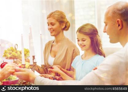 family, holidays, generation and people concept - smiling family having dinner and praying at home