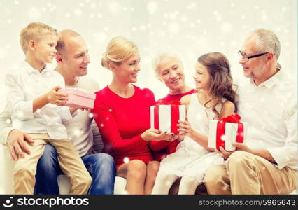 family, holidays, generation, christmas and people concept - smiling family giving each other presents at home