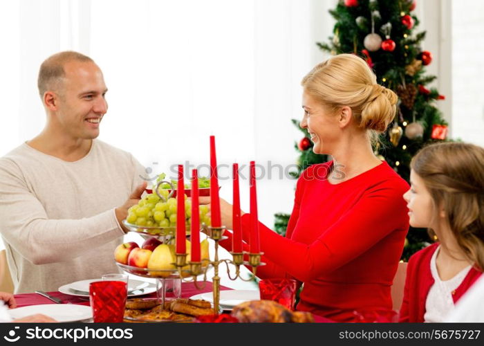 family, holidays, generation, christmas and people concept - smiling family having dinner at home