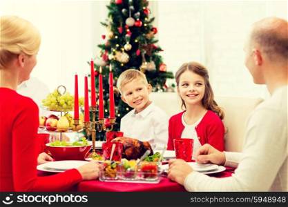 family, holidays, generation, christmas and people concept - smiling family having dinner at home