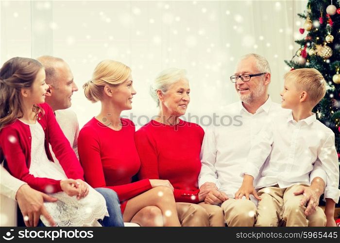 family, holidays, generation, christmas and people concept - smiling family sitting and talking on couch at home