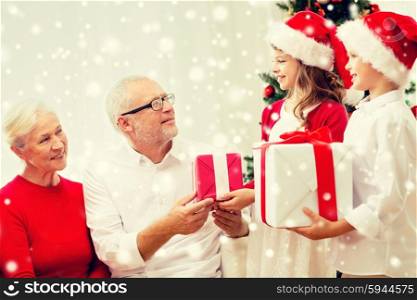 family, holidays, generation, christmas and people concept - smiling family with gift boxes at home