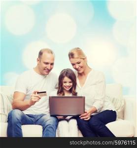 family, holidays, shopping, technology and people concept - happy family with laptop computer and credit card over blue lights background