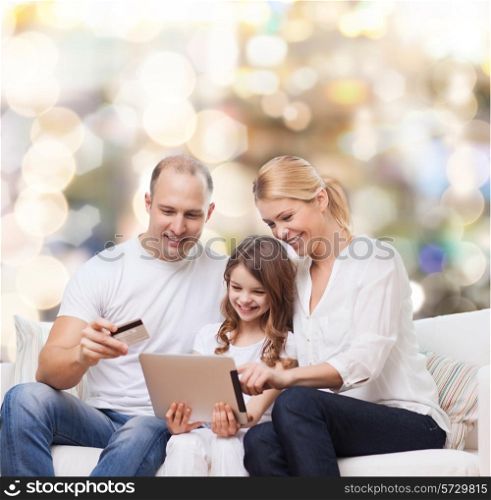 family, holidays, shopping, technology and people - smiling mother, father and little girl with tablet pc computer and credit card over lights background