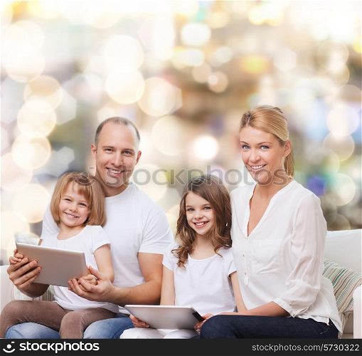 family, holidays, technology and people - smiling mother, father and little girls with tablet pc computers over lights background