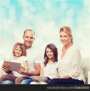 family, holidays, technology and people - smiling mother, father and little girls with tablet pc computers over blue lights background
