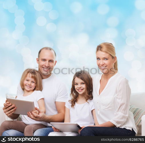 family, holidays, technology and people - smiling mother, father and little girls with tablet pc computers over blue lights background