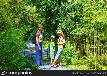 Family in beautiful summer park (grove of bamboo tree)