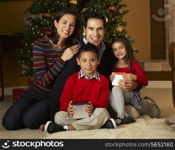Family In Front Of Christmas Tree