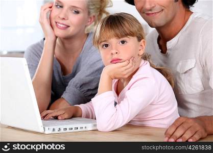 Family in front of laptop