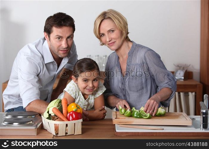 Family in kitchen cooking
