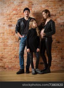 Family in leather clothes on brick wall background (normal version)