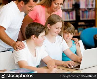 Family in library with books. Family in library