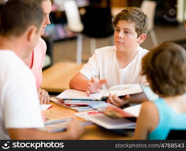 Family in library with books. Family in library