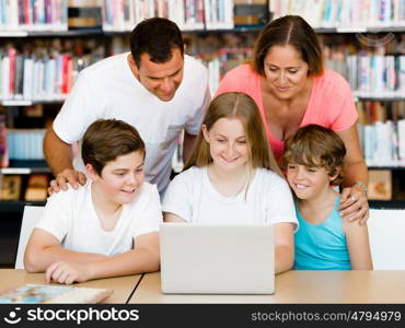 Family in library with books. Family in library