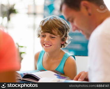 Family in library with books. Family in library