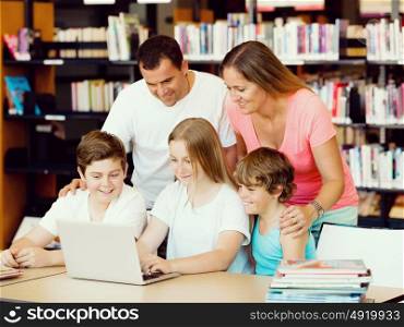 Family in library with books. Family in library