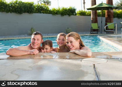 Family in outdoor swimming pool, portrait