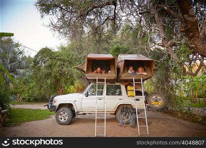 Family in sleeping tents on top of off road vehicle, Ruacana, Owamboland, Namibia