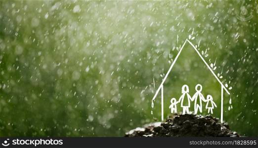Family in the house in the rain Insurance concept, future planning and home repairs concept