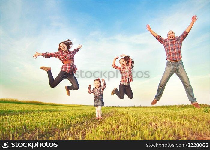 family jumping in the field