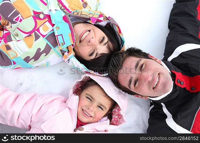 Family laying in the snow