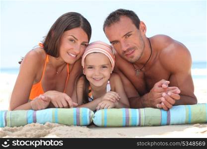 Family laying on beach