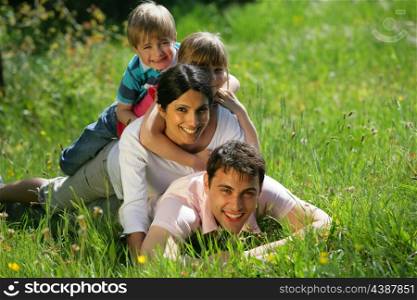 Family laying together in the park