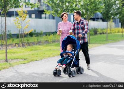 family, leisure and people concept - happy mother and father with little son in stroller and takeaway coffee walking along city street. family with baby in stroller and coffee in city