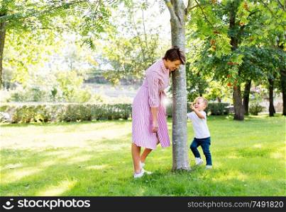 family, leisure and people concept - happy mother and little son having fun in summer park. happy mother and son having fun in summer park