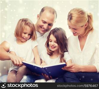 family, leisure, education and people - smiling mother, father and little girls reading book over snowflakes background