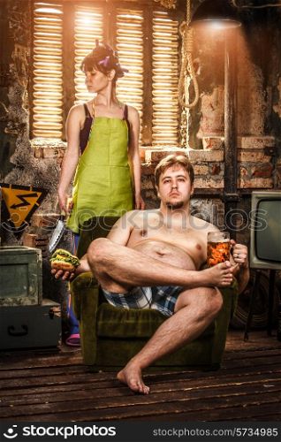 Family Life. Portrait of husband and wife in a poor slums room.