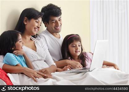 Family looking at laptop