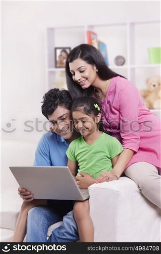 Family looking at laptop